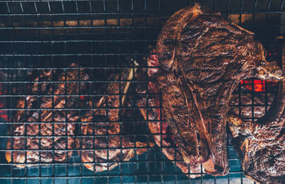 Directly above shot of meat on barbecue grill