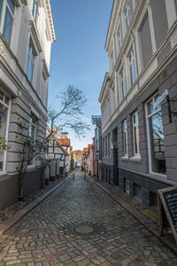 Empty alley amidst buildings in city