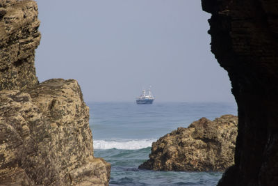 Scenic view of rocks and sea against sky
