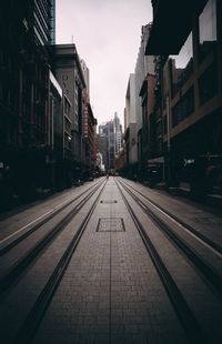 View of tramway on street amidst buildings in city