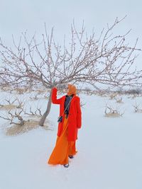 Person standing by bare tree against sky during winter in cappadocia turkey