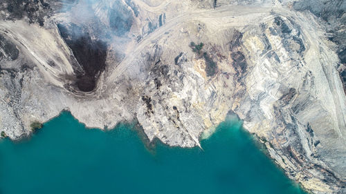 High angle view of water flowing through rocks