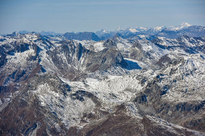 Aerial view of snowcapped mountains against sky