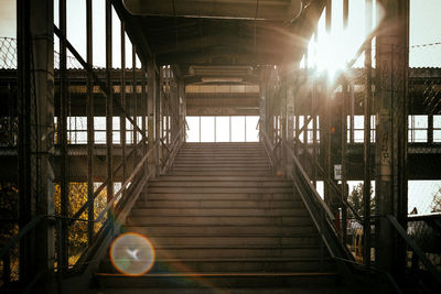 Steps leading towards bridge on sunny day