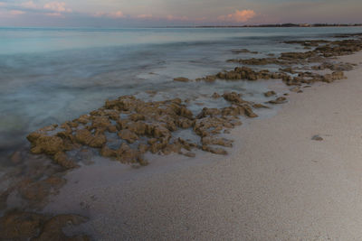 Scenic view of beach against sky during sunset