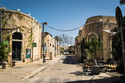 Street amidst buildings against sky