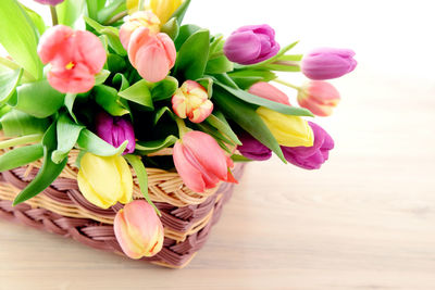 Close-up of tulips in basket on table