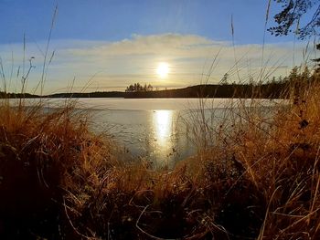 Scenic view of lake against sky during sunset