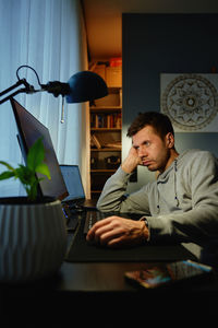 Portrait of young woman working at table
