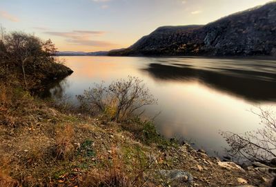 Scenic view of lake against sky during sunset