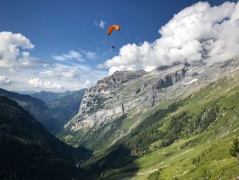 Scenic view of a paraglider flying over swiss alps