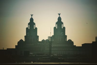 Low angle view of built structure at sunset