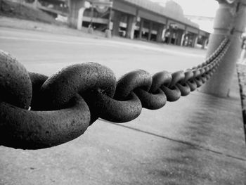 Close-up of rope tied to metal chain