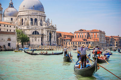 Boats in canal with buildings in background