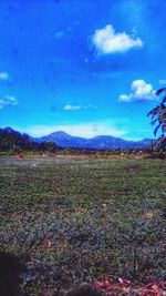 Scenic view of landscape against cloudy sky