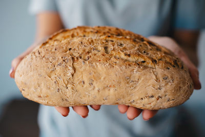 Midsection of man holding bread