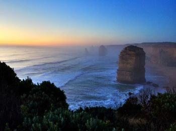 Scenic view of sea against clear sky during sunset