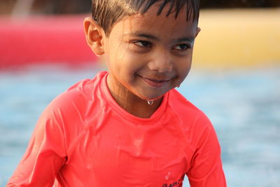 Close-up of smiling boy at pool