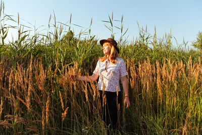 Portrait of a beautiful blonde middle-aged woman near reed and pampas grass. youth, love, romantic