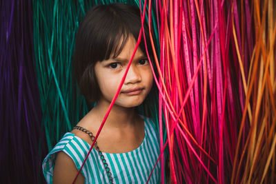 Portrait of girl by colorful curtain