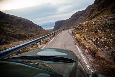 Car moving on road against sky