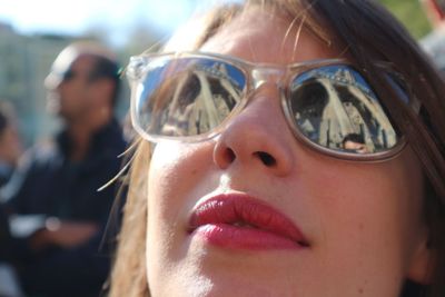 Close-up of young woman wearing sunglasses on sunny day