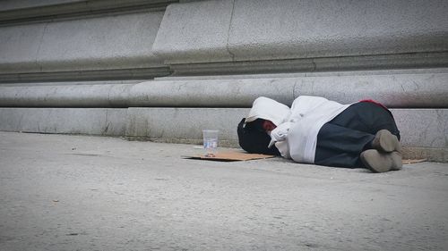 Man sleeping on road