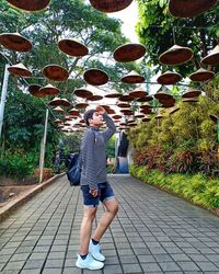 Rear view of woman walking on footpath