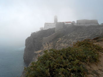 Scenic view of sea and mountains against sky