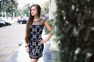 Beautiful young woman standing in park