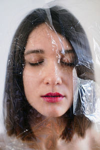 Portrait of attractive woman covered with plastic bag