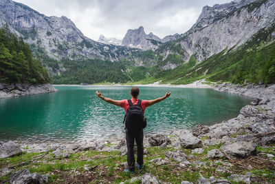 Rear view of man jumping in lake