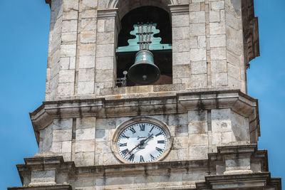 Low angle view of clock tower against sky