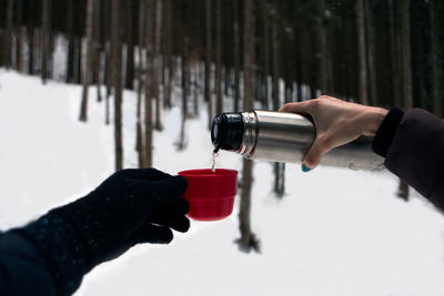 Close-up of human hands pouring tea