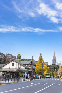 Group of people walking on road in city