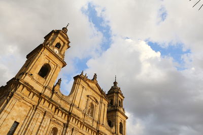 Low angle view of church against cloudy sky