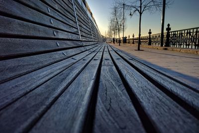 Surface level of footpath against sky during winter