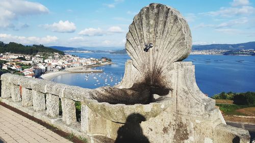 Panoramic view of sea and city against sky