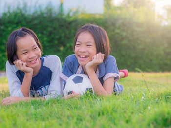 Portrait of a smiling girl lying on grass