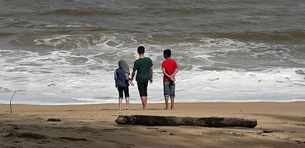 Rear view of people on beach