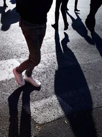 Low section of people standing on road