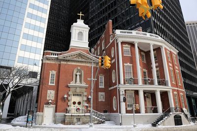 Low angle view of statue against buildings in city