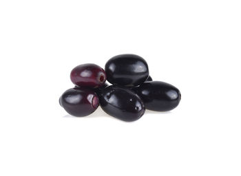 Close-up of black fruit against white background