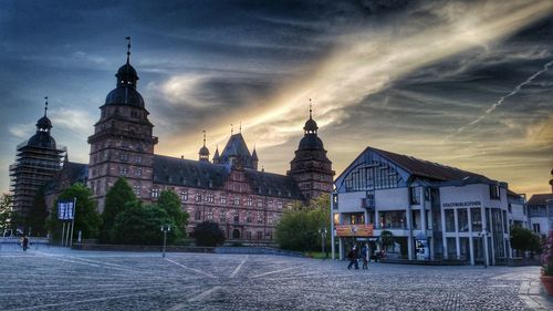 Buildings in city against sky during sunset