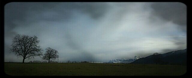 Scenic view of landscape against cloudy sky