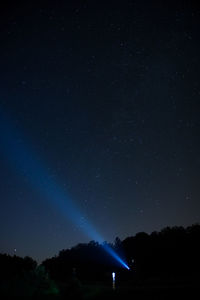 Low angle view of silhouette trees against sky at night