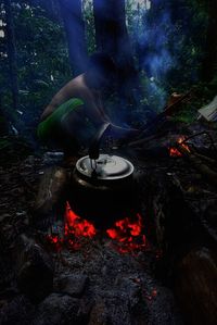 Low section of man wearing shoes on barbecue grill