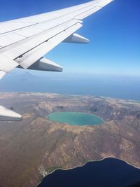 Aerial view of airplane wing over landscape