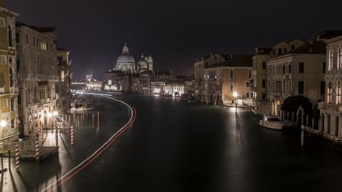 View of canal in city at night