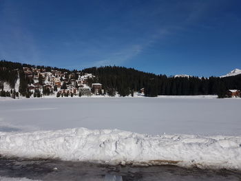 Scenic view of snow covered land against blue sky